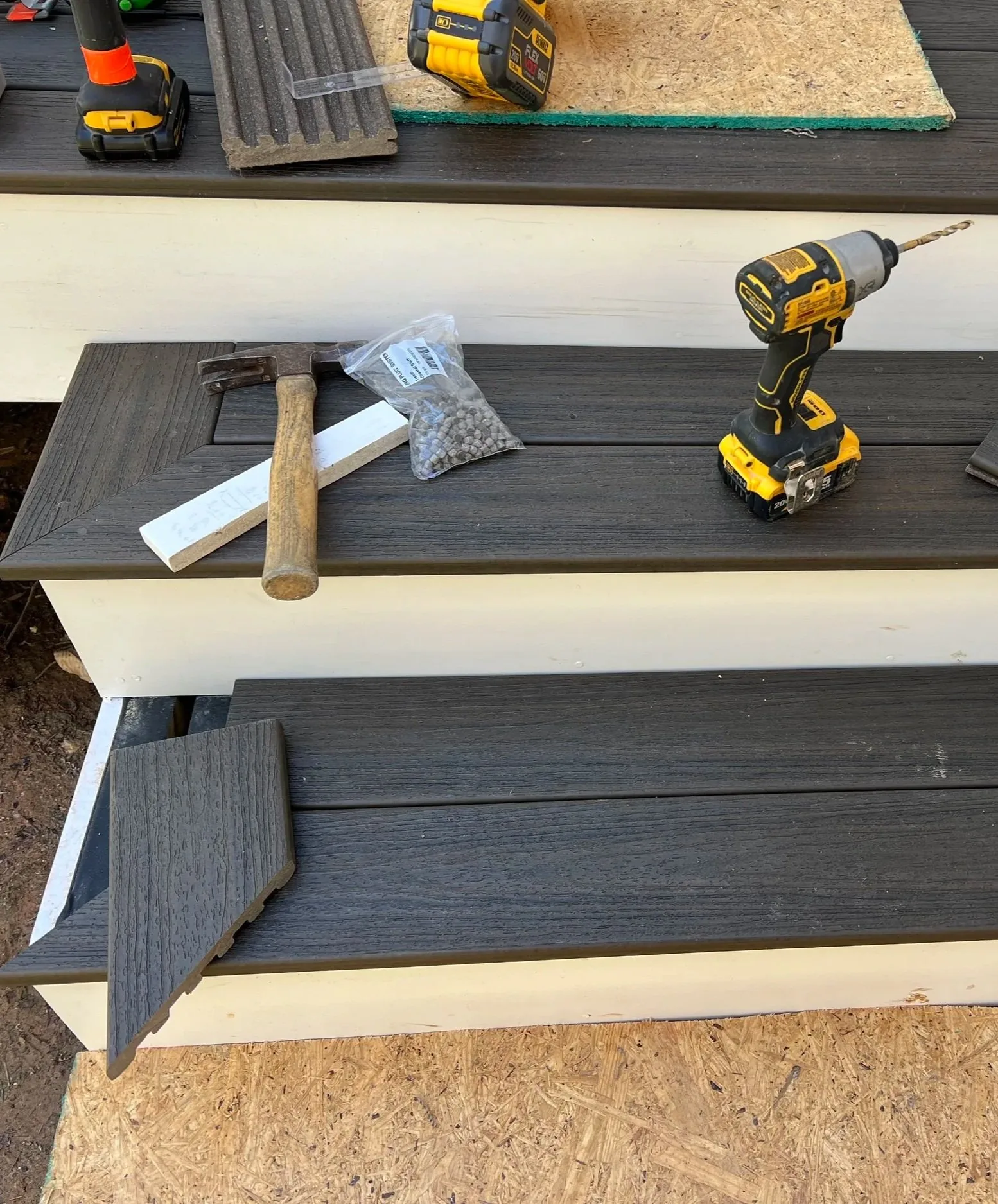 Composite deck mid-repair with tools on freshly replaced decking boards in Wake Forest, NC