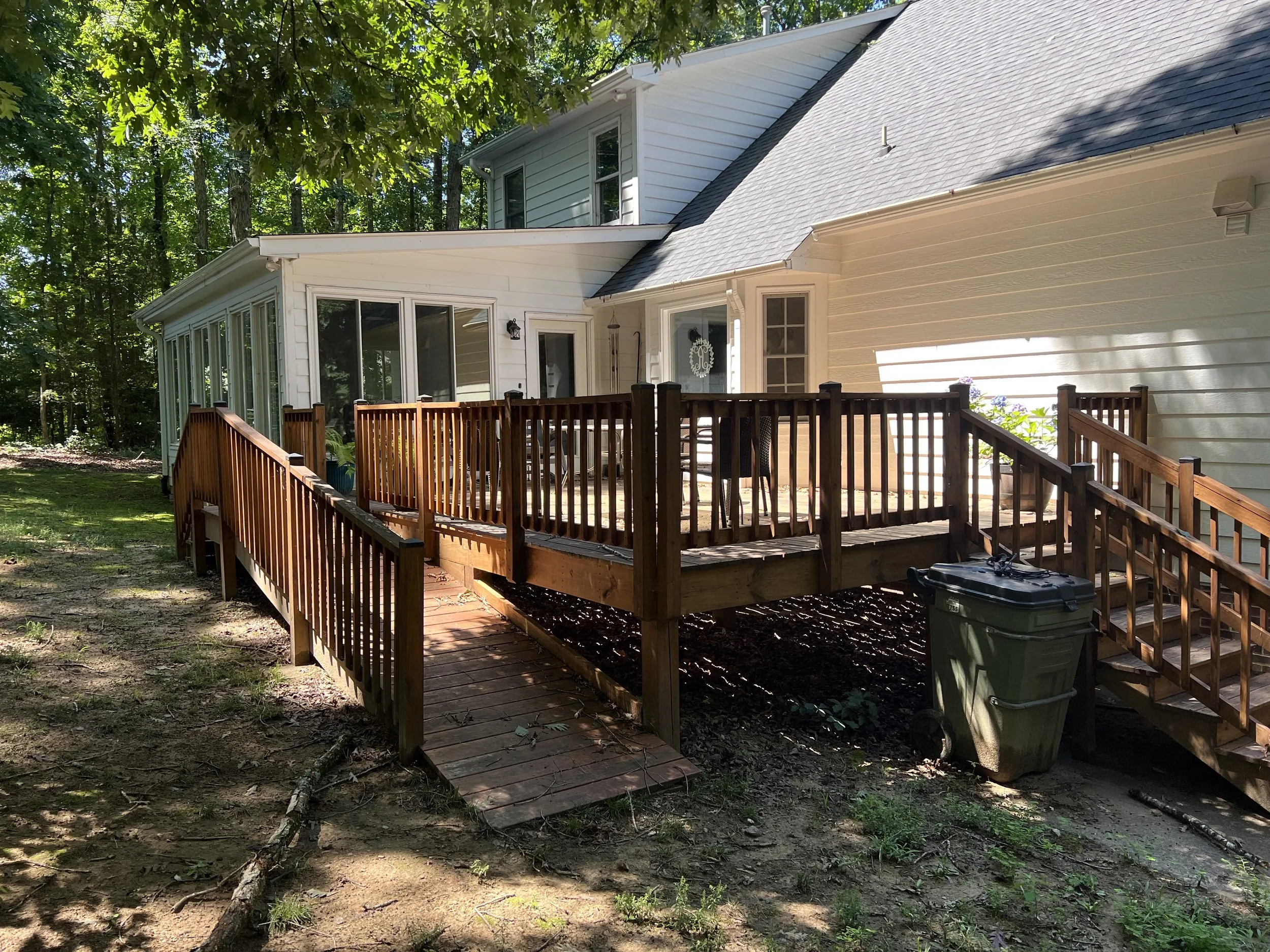 Wide backyard wood deck with railing built by Bright Ridge Construction